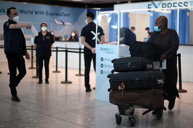 A passenger walks with his bags at the Terminal 5 departures area at Heathrow Airport in London. Reuters
