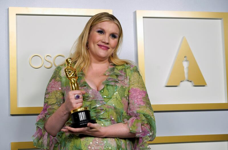 Best Original Screenplay: Emerald Fennell, for 'Promising Young Woman', poses in the press room at the Oscars on Sunday, April 25, 2021, at Union Station in Los Angeles. Reuters