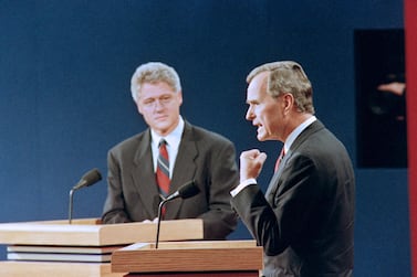 US President George Bush (R) answers a question while democratic Presidential candidate Bill Clinton listen on October 11, 1992 at the athletic center at Washington University in St Louis during the first of three US presidential debates.. (Photo by Eugene GARCIA / AFP)