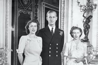 A young Princess Elizabeth at Buckingham Palace with her husband to be, Lieut Philip Mountbatten, and her sister, Princess Margaret. PA Images