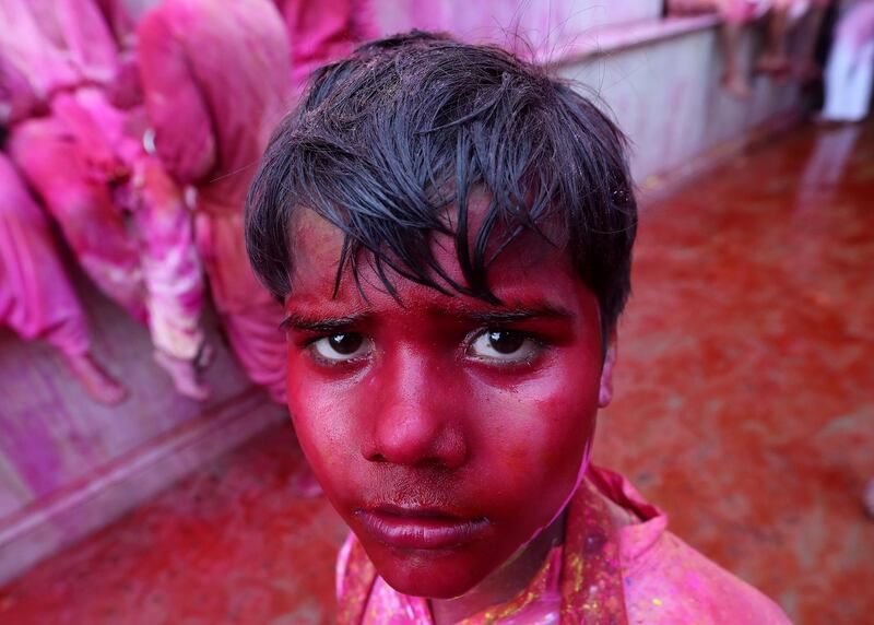 A young Indian devotee smeared with powdered colors celebrates the Lathmar Holi festival at the Nandgram temple in Nandgaon, Mathura, India, 05 March 2020. Holi is the Hindu spring festival of colours. EPA