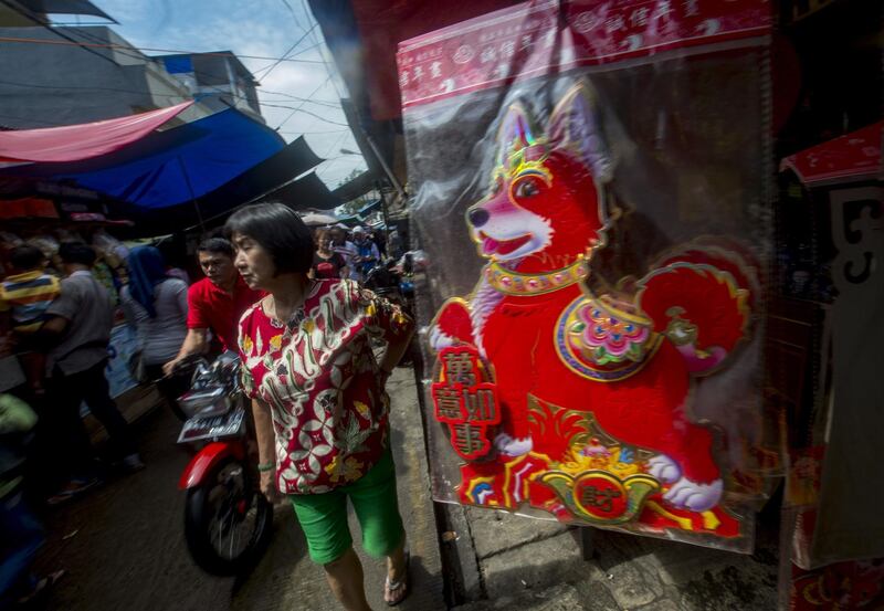 People walk past a kiosk selling Chinese decorations in Jakarta. Bay Ismoyo / AFP Photo
