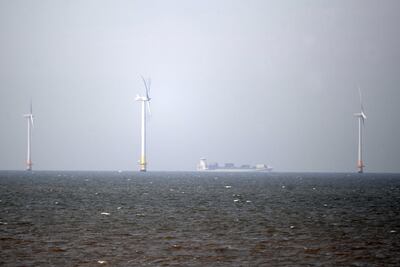 A boat passes an offshore wind farm near Whitstable Bay. Powering up Britain hopes for an expansion of offshore wind generation, particularly in floating wind capacity. EPA