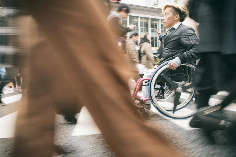 A Japanese man in a wheelchair in the Shibuya Ward of Tokyo, Japan.