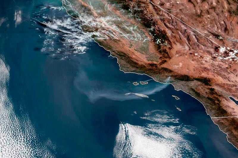 This satellite image from the National Oceanic and Atmospheric Administration (NOAA) shows a plume of smoke from the Saddleridge wildfire streaming out over the Pacific Ocean from the Los Angeles area of Southern California, center right, Friday morning, Oct. 11, 2019. (NOAA via AP)