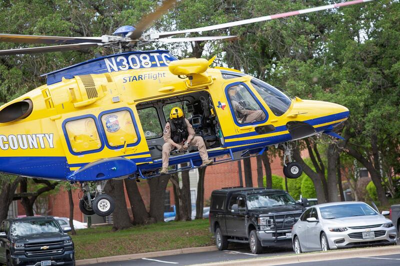 A Travis County Starlight medical helicopter lands to pick up law enforcement personnel at the scene of a deadly shooting at an apartment complex in Austin, Texas. Reuters