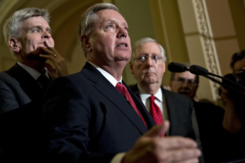 Senator Lindsey Graham, a Republican from South Carolina, center, speaks as Senate Majority Leader Mitch McConnell, a Republican from Kentucky, right, and Senator Bill Cassidy, a Republican from Louisiana, listen during a news conference after a Republican policy meeting luncheon at the U.S. Capitol in Washington, D.C., U.S., on Tuesday, Sept. 26, 2017. Senate Republicans gave up on their last-ditch proposal to repeal Obamacare today as opposition in their own ranks ended months of fruitless efforts to gut the Affordable Care Act. Photographer: Andrew Harrer/Bloomberg
