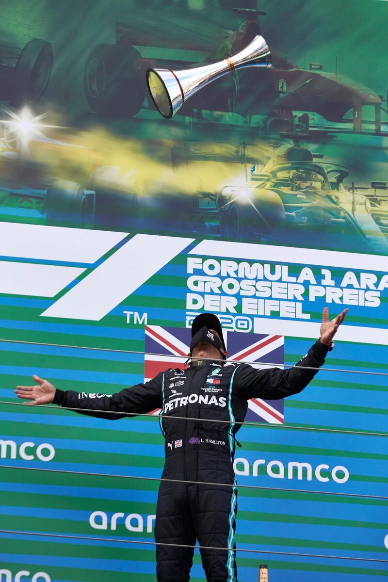 Britsh driver Lewis Hamilton celebrates on the podium after winning the Eifel Grand Prix at the Nurburgring in Germany on Sunday, October 11. Reuters