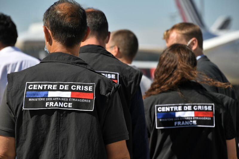 Crisis management specialists from France's Foreign Affairs ministry board a Airbus A330, at Roissy airport. AFP