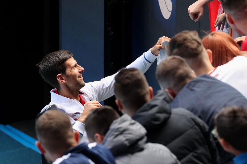 Serbia's Novak Djokovic signs autographs for fans. AFP