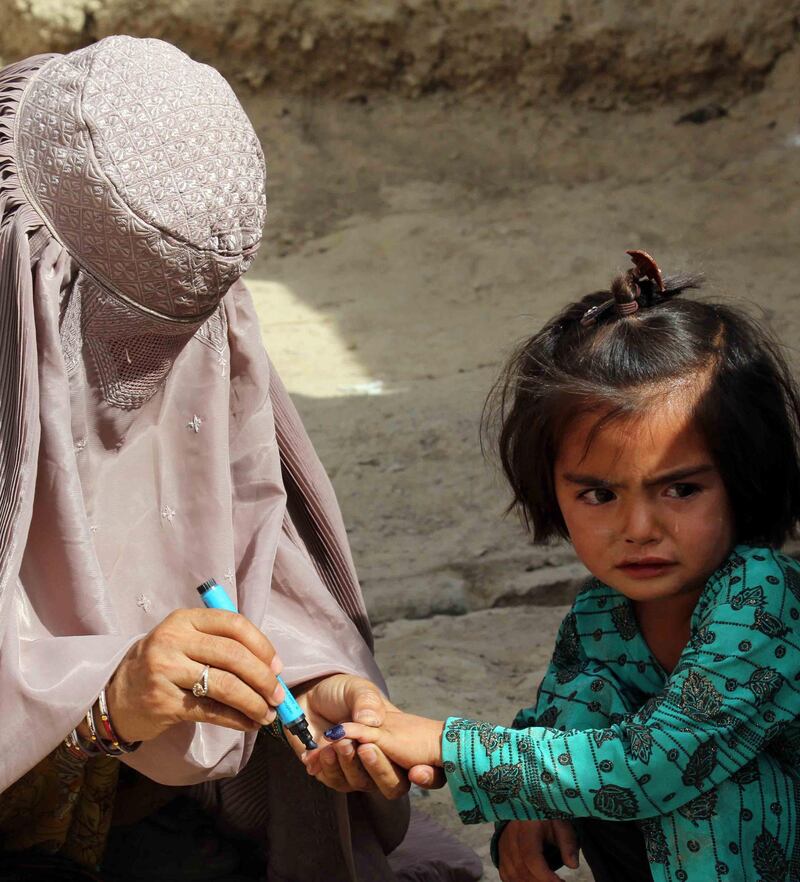 Health workers administer polio vaccination to children in Kandahar, Afghanistan. EPA