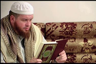 This image provided by New Zealand 3 News/MediaWorks via APTN shows Mark Taylor, who converted to Islam and joined ISIS in Syria, as he reads the Quran in his native New Zealand. APTN