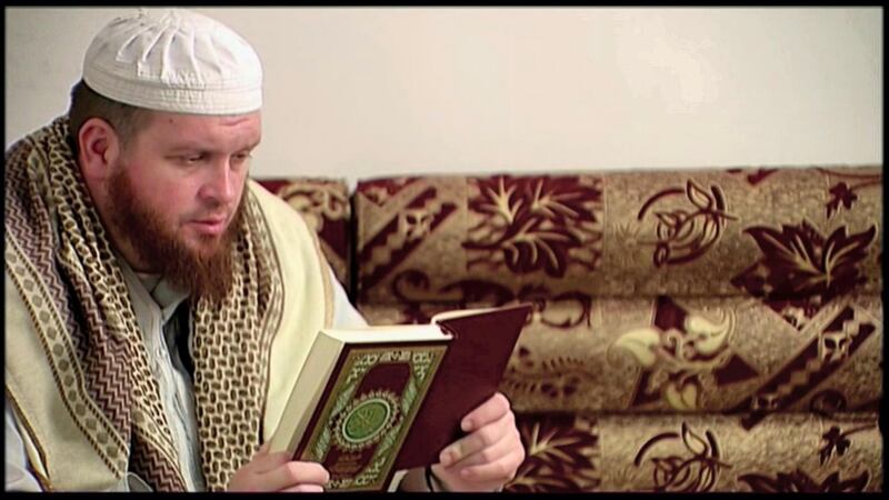 This image provided by New Zealand 3 News/MediaWorks via APTN shows Mark Taylor, who converted to Islam and is now thought to be in Syria, as he reads the Quran in his native New Zealand. Taylor, 42, began visiting a mosque in the city of Hamilton some years ago, and resurfaced 2014 in Syria. Authorities estimate only a half-dozen New Zealanders have traveled to Syria to fight with the Islamic State group. It’s unclear how they’ve become radicalized, although Taylor’s case might provide a clue: He’s acknowledged listening to the sermons of the late U.S.-born al-Qaida preacher Anwar al-Awlaki.  (New Zealand 3 News/MediaWorks via APTN)  AUSTRALIA OUT; NEW ZEALAND OUT