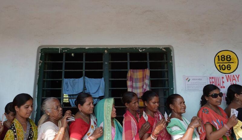 Indian voters queue to cast their ballots at a polling station in Singur, some 45 kms north of Kolkata. Dibyangshu Sarkar / AFP