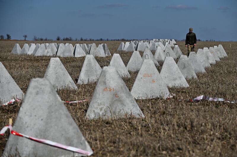 Danylo, commander of an engineering and sapper company of the Ukrainian Armed Forces, inspects pyramidal anti-tank obstacles known as 'dragon's teeth' before installing them into a new fortification line in Zaporizhzhia region. Reuters