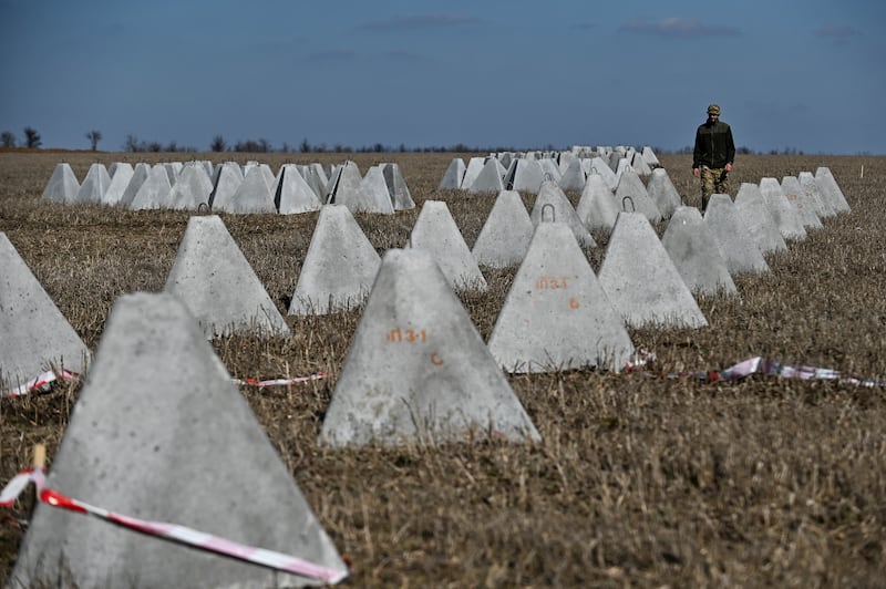 Danylo, commander of an engineering and sapper company of the Ukrainian Armed Forces, inspects pyramidal anti-tank obstacles known as 'dragon's teeth' before installing them into a new fortification line in Zaporizhzhia region. Reuters