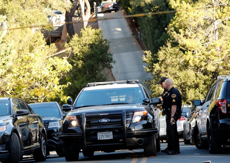 epa07965535 Contra Costa County Sheriffs (R) talk with Orinda Police (L) near a scene of a shooting at a Halloween Party in short-term rental house in Orinda, California, USA, 01 November 2019. According to reports, four people were killed and several injured in a shooting on 31 October at a Halloween party in a private house.  EPA/JOHN G. MABANGLO