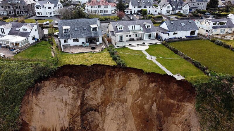 Houses are seen on the edge of a cliff after it collapsed in the village of Nefyn, Wales, Britain, April 20, 2021. Picture taken with a drone. REUTERS/Carl Recine     TPX IMAGES OF THE DAY