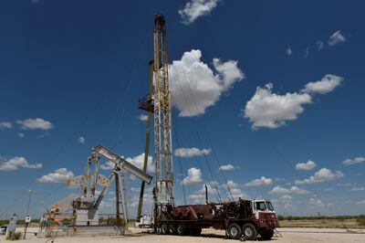 A work-over rig performs maintenance on an oil well in the Permian Basin oil production area near Wink, Texas. Reuters
