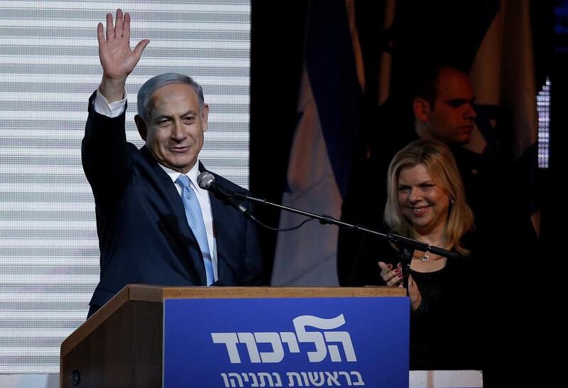 Israeli prime minister Benjamin Netanyahu waves to supporters beside his wife, Sara, at party headquarters in Tel Aviv on March 18, 2015. Nir Elias/Reuters