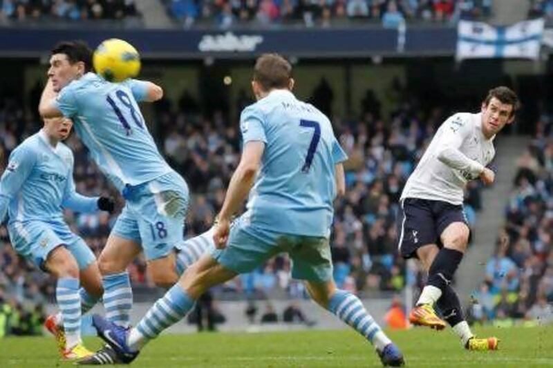 Tottenham Hotspur's Gareth Bale, right, shoots and score a goal against Manchester City during their English Premier League match at Etihad Stadium, Manchester, England, on January 22, 2012.