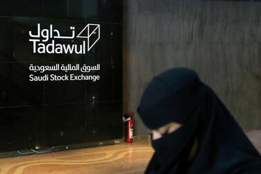 A Saudi woman walks at the Tadawul market in Riyadh. The exchange has transformed its corporate sector ahead of its IPO later this year. Reuters