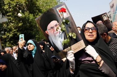 Iranians hold posters depicting Iranian supreme leader Ayatollah Ali Khamenei mourn during a ceremony in Tehran, Iran, on June 27, 2019, marking the return of bodies of Iranian soldiers killed in the Iran-Iraq war. EPA