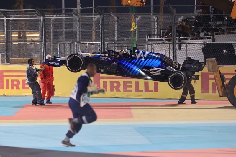 Race marshals remove the car of Williams driver George Russell after a crash. AFP