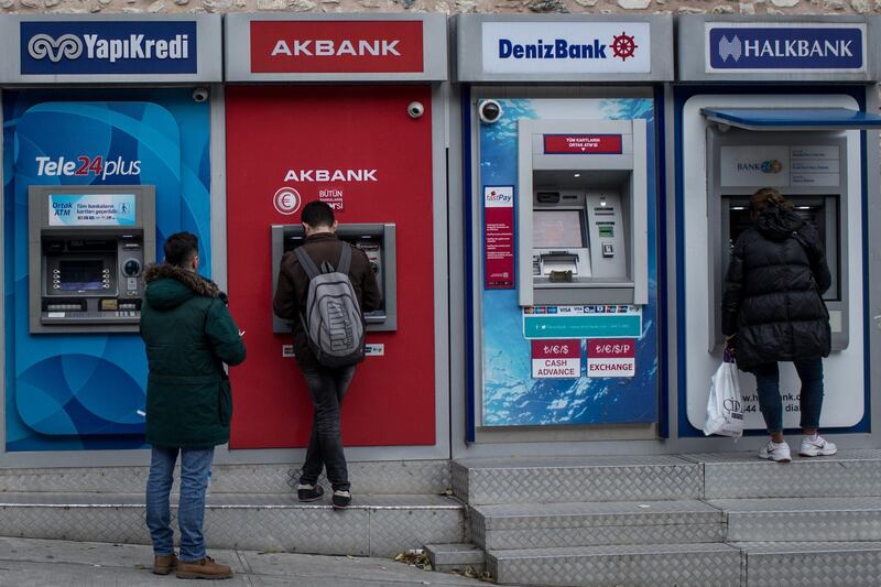 ISTANBUL, TURKEY - DECEMBER 01: People use Turkish bank ATM machines on December 1, 2017 in Istanbul, Turkey. The trial of Mr. Reza Zarrab, an Iranian-Turk who ran a foreign exchange and gold dealership continues in New York. In recent days testimony Mr. Zarrab implicated a number of Turkish Banks as well as high ranking government officials. Mr. Zarrab is accused of managing a billion-dollar scheme to smuggle gold for Iranian oil and conspiring to violate United States sanctions against Iran. (Photo by Chris McGrath/Getty Images)