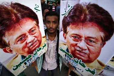A supporter holds portraits of former President Pervez Musharraf during a protest against sentencing Musharraf to death in high treason case in Karachi, Pakistan, December 18, 2019. SHAHZAIB AKBER
