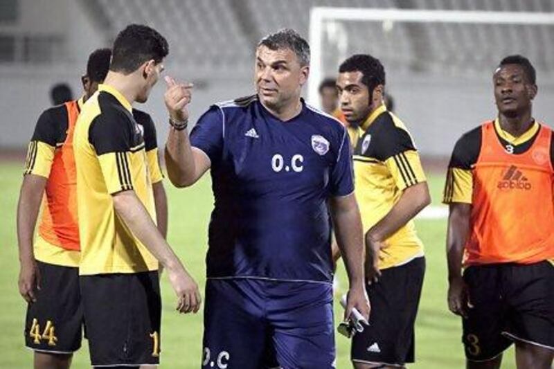 Al Ain coach Cosmin Olaroiu, centre, is asking for all of the club supporters to come to the season finale on Friday night and help celebrate Al Ain's second straight league title. Silvia Razgova / The National