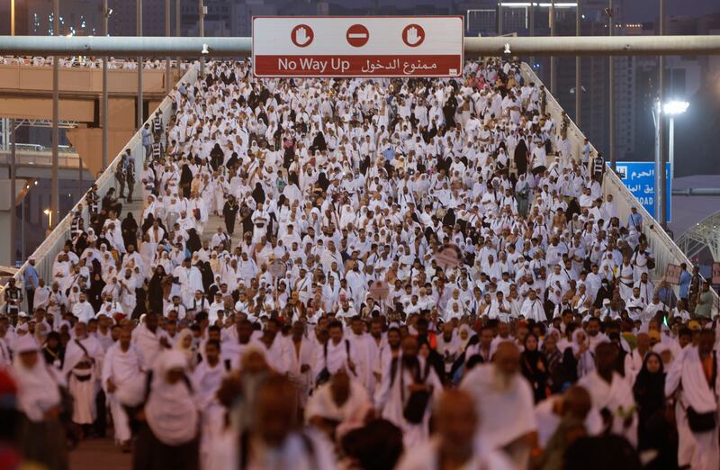 Pilgrims walk to cast their stones. Reuters