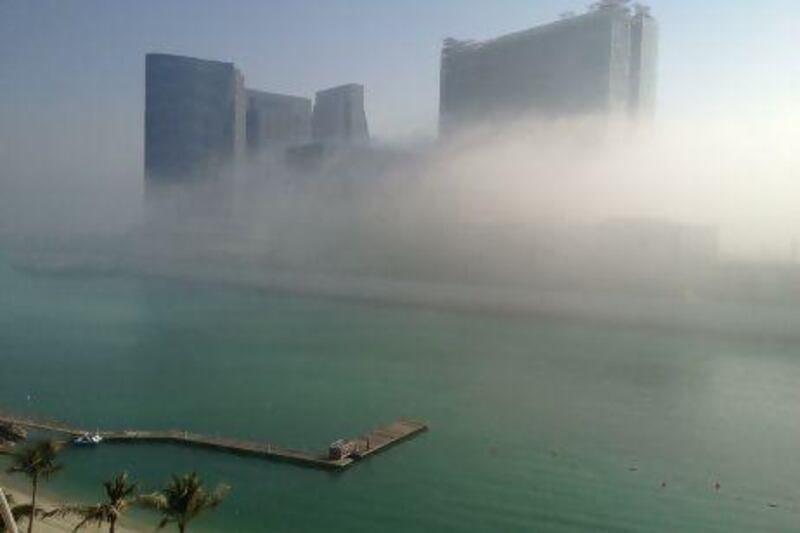 Buildings on Al Maryah Island wrapped in fog this morning. Brian Kerrigan / The National
