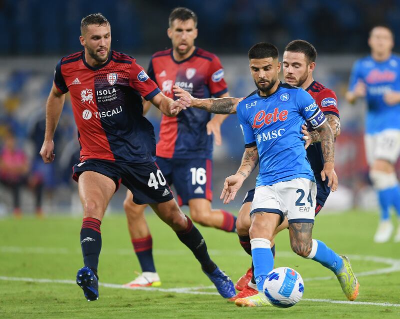 Lorenzo Insigne of Napoli vies with Nahitan Nandez and Sebastian Walukiewicz of Cagliari. Getty Images