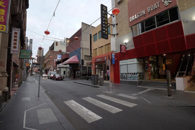 A street stands empty in the Chinatown area of Melbourne, Australia. The Australian government said it will enforce more stringent controls to slow the virus spread, closing pubs, casinos, restaurants and other venues after the number of infections surged. Bloomberg