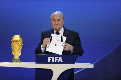 (FILES) This file photo taken on December 02, 2010 shows FIFA President Sepp Blatter holding up the name of Qatar during the official announcement of the 2022 World Cup host country at the FIFA headquarters in Zurich.
The opening this week of the glittering Louvre Abu Dhabi museum marks the latest stage in a multi-billion-dollar "soft power" showdown between energy giants Qatar and the United Arab Emirates. Culture, media and sports have turned into battlegrounds for branding and global recognition.
 / AFP PHOTO / Philippe DESMAZES
