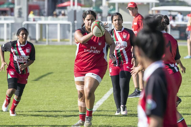 ABU DHABI, UNITED ARAB EMIRATES. 29 November 2018. First day of the Rugby Sevens Tournament. Al Maha School girls team of all Emirati Female Players (Red and black colours). Team warm up before the match. (Photo: Antonie Robertson/The National) Journalist: Paul Radley. Section: Sport.