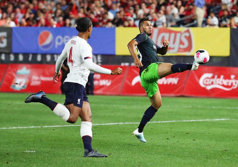 Luiz Phellype of Sporting, right, in action against Virgil van Dijk of Liverpool. AFP