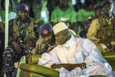 Incumbent Gambian President Yahya Jammeh listens to one of his aides in Banjul on November 29, 2016, during the closing rally of the electoral campaign of the Alliance for Patriotic Reorientation and Construction (APRC). - More than 880,000 voters are expected to cast their ballots when the west African country goes to the polls on December 1, 2016. Jammeh has won four elections with his ruling Alliance for Patriotic Reorientation and Construction, following a 2002 constitutional amendment lifting term limits. Rights bodies and media watchdogs including Reporters Without Borders (RSF) accuse Jammeh of cultivating a "pervasive climate of fear" and of crushing dissent against his regime, one cause of the mass exodus of Gambian youths to Europe. (Photo by MARCO LONGARI / AFP)