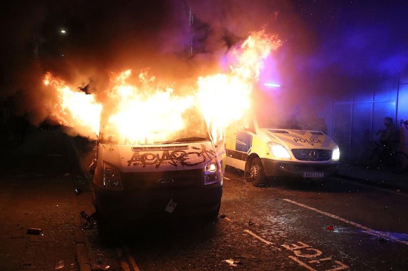 A vandalised police van on fire outside Bridewell Police Station, in Bristol. AP Photo
