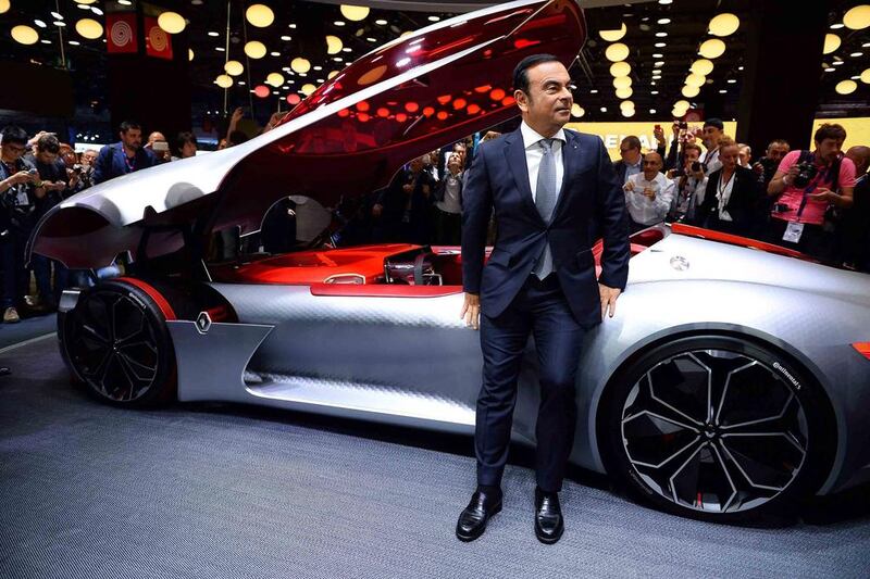 French carmaker Renault CEO Carlos Ghosn leans against the concept car Trezor on the first day of  the press days of the Paris motor Show, on September 29, 2016. / AFP / ERIC PIERMONT