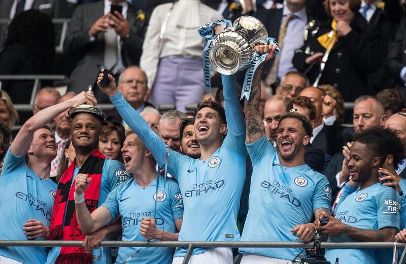 LONDON, ENGLAND - MAY 18: John Stones and Kyle Walker of Manchester City lift FA trophy during the FA Cup Final match between Manchester City and Watford at Wembley Stadium on May 18, 2019 in London, England. (Photo by Sebastian Frej/MB Media/Getty Images)