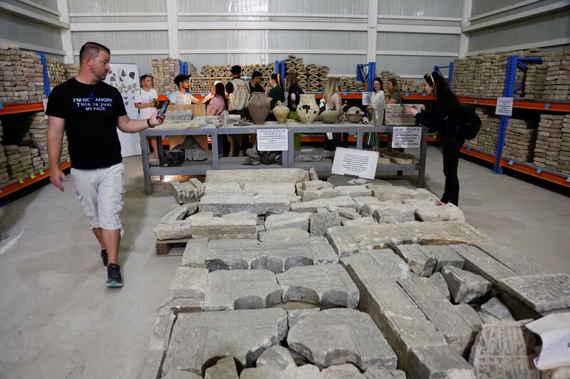 Tourists look at the archaeological artefacts from Al Nuri mosque.