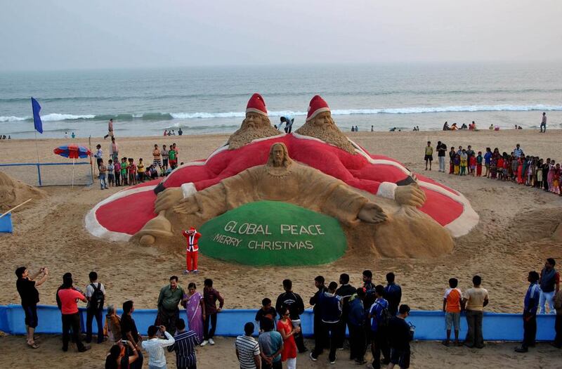 People admire a Christmas sand sculpture on Golden Sea Beach at Puri, Bhubaneswar, India. Asit Kumar/ AFP