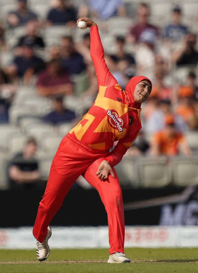 Birmingham Phoenix's leg-spinner Abtaha Maqsood bowls during The Hundred match at Old Trafford wearing a hijab.
