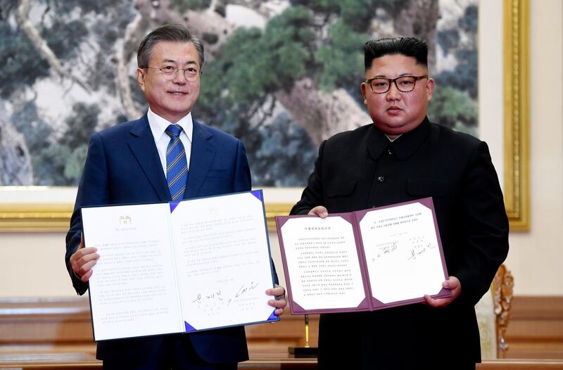 South Korean President Moon Jae-in, left, and North Korean leader Kim Jong Un hold documents after signing at the Paekhwawon State Guesthouse in Pyongyang, North Korea, Wednesday, Sept. 19, 2018. This week's inter-Korean summit talks ended with a set of sweeping agreements on denuclearization of the Korean Peninsula, reducing a military standoff and other reconciliation issues. (Pyongyang Press Corps Pool via AP)