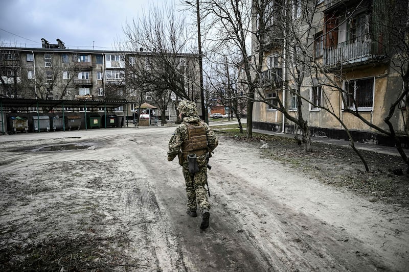 A Ukrainian Army soldier trudges through the wintry streets of Schastia on patrol. AFP