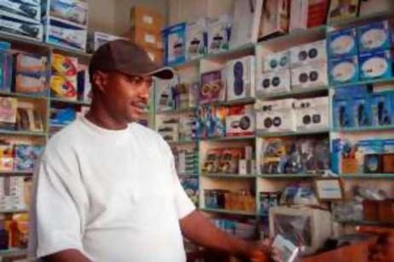 Joseph Muchai demonstrates a tape recorder in his shop in downtown Nairobi. Muchai is one of hundreds of Kenyan businessmen that travel to the UAE to buy products to sell in Kenya. MATT BROWN/THE NATIONAL *** Local Caption ***  Trader 2.jpg