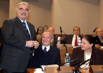 FILE - In this Feb. 14, 2005 file photo former Lebanese Prime Minister Rafik Hariri, left, Parliament member Marwan Hamadeh and Bahiyah Hariri, sister of President Hariri, are pictured during a meeting at the Parliament in Beirut. More than 15 years after the truck bomb assassination of former Lebanese Prime Minister Rafik Hariri in Beirut, a U.N.-backed tribunal in the Netherlands is announcing verdicts this in the trial of four members of the militant group Hezbollah allegedly involved in the killing, which deeply divided the tiny country. (AP Photo, File)