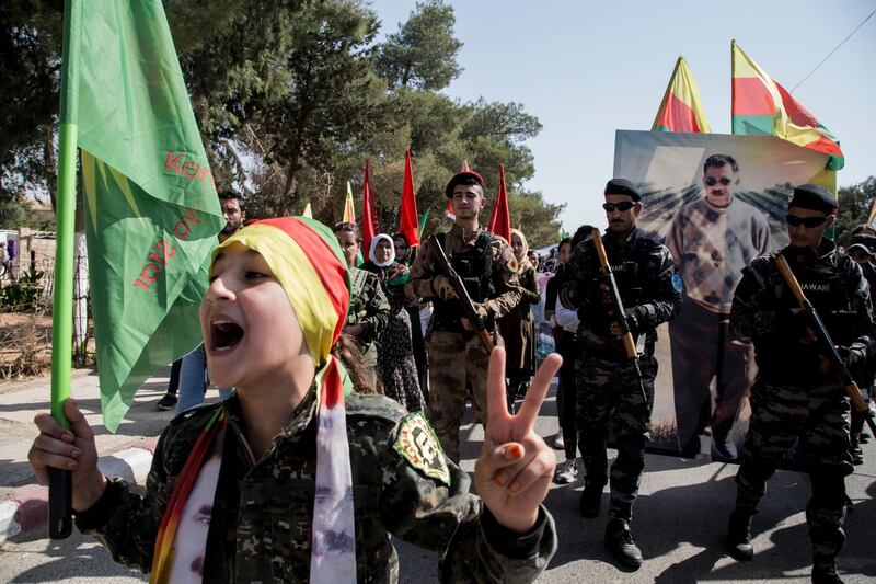 Fighters of the Syrian Democratic Forces, SDF, march during a demonstration against possible Turkish military operation in their areas in Al-Qahtaniya, Syria. AP Photo